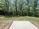 A spacious backyard with lush greenery surrounded by mature trees offers a private outdoor space at 211 W Saltgrass Ln, Smithfield, NC 27577