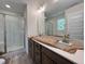 New bathroom featuring double sinks, a modern mirror, and a glass shower stall at 211 W Saltgrass Ln, Smithfield, NC 27577