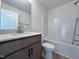 Bright bathroom featuring a vanity with stone countertop and a shower over bath at 211 W Saltgrass Ln, Smithfield, NC 27577