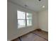 Bright bedroom with natural light from a double-hung window and an electrical outlet at 211 W Saltgrass Ln, Smithfield, NC 27577