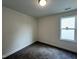Bedroom with plush carpet, neutral walls, a ceiling light, and a window offering natural light at 211 W Saltgrass Ln, Smithfield, NC 27577
