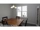 Well-lit dining area featuring a wooden table, neutral walls, and a large window at 211 W Saltgrass Ln, Smithfield, NC 27577