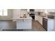 A modern kitchen features stainless appliances, stone countertops and a stylish island at 211 W Saltgrass Ln, Smithfield, NC 27577