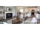 Open-concept living space features a fireplace, staircase, and seamless flow to the kitchen at 211 W Saltgrass Ln, Smithfield, NC 27577