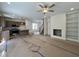 Open floor plan with kitchen island, fireplace, built-in bookcases, and stairs to the upper level at 211 W Saltgrass Ln, Smithfield, NC 27577