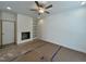 Living room featuring a built-in bookcase, fireplace, and a ceiling fan at 211 W Saltgrass Ln, Smithfield, NC 27577