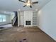 Living room featuring a built-in bookcase, fireplace, staircase, and ceiling fan at 211 W Saltgrass Ln, Smithfield, NC 27577