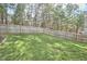 Lush backyard featuring a well-maintained lawn, bordered by a wooden fence for privacy, perfect for outdoor enjoyment at 215 Strolling Way, Durham, NC 27707