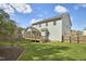 Expansive backyard with a screened porch, wooden deck, and well-maintained lawn at 215 Strolling Way, Durham, NC 27707