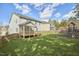Spacious backyard with a deck and screened porch, ideal for relaxing and entertaining with play set at 215 Strolling Way, Durham, NC 27707