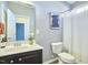 Well-lit bathroom featuring a vanity with a white countertop and a shower with a white curtain at 215 Strolling Way, Durham, NC 27707