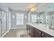 Spacious bathroom features double sink vanity, large mirror and tiled floor at 215 Strolling Way, Durham, NC 27707