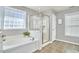 Bright bathroom features a soaking tub and glass-enclosed shower at 215 Strolling Way, Durham, NC 27707