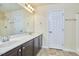 Bathroom featuring a double sink vanity, a large mirror, and neutral finishes at 215 Strolling Way, Durham, NC 27707