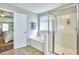 Bright bathroom features soaking tub, glass enclosed shower, and an open doorway at 215 Strolling Way, Durham, NC 27707