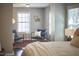 Bedroom with stylish chairs, natural light from windows and elegant décor at 215 Strolling Way, Durham, NC 27707