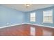 Bedroom with hardwood floors, natural light from two large windows at 215 Strolling Way, Durham, NC 27707