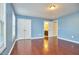 Spacious bedroom with hardwood floors, two large windows, and bathroom access at 215 Strolling Way, Durham, NC 27707