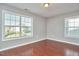 Bedroom with hardwood floors, natural light from two large windows at 215 Strolling Way, Durham, NC 27707