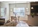 Open concept dining area with modern lighting, large windows, and seamless flow to the kitchen at 215 Strolling Way, Durham, NC 27707