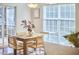 Inviting dining area featuring a wooden table and chairs with natural lighting from windows and sliding doors at 215 Strolling Way, Durham, NC 27707