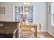 Bright dining area with natural light, a wooden table, and chairs near sliding glass doors at 215 Strolling Way, Durham, NC 27707