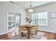 A cozy dining area features hardwood floors, a wooden table with four chairs, and a sliding door to the outside at 215 Strolling Way, Durham, NC 27707