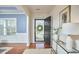 Welcoming entryway featuring a black front door, hardwood floors, and stylish console table with decorative accents at 215 Strolling Way, Durham, NC 27707