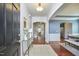 Inviting entryway with wood floors, decorative rug, console table, and views into dining and living spaces at 215 Strolling Way, Durham, NC 27707