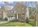 Beautiful two-story home with a manicured lawn and mature trees surrounding the property at 215 Strolling Way, Durham, NC 27707