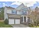 Charming two-story home with a two-car garage and stone accents on the lower level at 215 Strolling Way, Durham, NC 27707