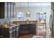 Contemporary kitchen with wooden cabinets, sleek appliances, and a view into the light-filled dining area at 215 Strolling Way, Durham, NC 27707