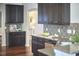 Stylish kitchen with dark wood cabinetry, granite countertops, and stainless steel appliances at 215 Strolling Way, Durham, NC 27707
