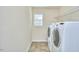 Convenient laundry room equipped with washer, dryer, and shelving at 215 Strolling Way, Durham, NC 27707