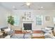 A well-lit living room features hardwood floors, a fireplace, and neutral decor, creating a serene and inviting atmosphere at 215 Strolling Way, Durham, NC 27707