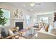 A spacious living room features hardwood floors, a fireplace, and an open layout, seamlessly connecting to the dining area at 215 Strolling Way, Durham, NC 27707