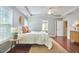 A bright main bedroom features hardwood floors, a tray ceiling, and stylish decor, providing a comfortable and elegant space at 215 Strolling Way, Durham, NC 27707
