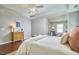 A calming main bedroom includes hardwood floors, tray ceilings, and ample natural light for a serene and inviting space at 215 Strolling Way, Durham, NC 27707