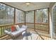 Relaxing screened porch featuring comfortable seating and a view of the private backyard at 215 Strolling Way, Durham, NC 27707