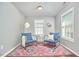 A charming sitting room features hardwood floors, comfortable seating, and natural light, perfect for relaxation and reading at 215 Strolling Way, Durham, NC 27707
