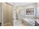 This bathroom features a soaking tub, separate shower, and travertine tile at 22 Hill Row Ln, Clayton, NC 27527