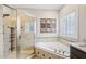 This bathroom features a soaking tub, separate shower, and travertine tile at 22 Hill Row Ln, Clayton, NC 27527