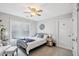 Cozy bedroom features neutral carpet, a ceiling fan, window with blinds, and stylish decor at 22 Hill Row Ln, Clayton, NC 27527