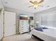 Neutral bedroom offers carpet, a ceiling fan, closet door, and a mounted television for relaxation at 22 Hill Row Ln, Clayton, NC 27527