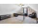 Bright bonus room with neutral carpet, ceiling fan, desk, shelves, and leather chair, creating a versatile space at 22 Hill Row Ln, Clayton, NC 27527