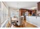 Bright dining area features a wood table, upholstered chairs, hardwood floors, and flows into the kitchen at 22 Hill Row Ln, Clayton, NC 27527