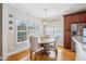 Bright dining area features a wood table, upholstered chairs, hardwood floors, and stylish light fixture at 22 Hill Row Ln, Clayton, NC 27527