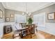 Elegant dining room featuring wainscotting, a modern chandelier, and natural lighting at 22 Hill Row Ln, Clayton, NC 27527