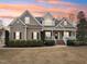 Charming home boasts a covered porch, manicured lawn, and mature landscaping at 22 Hill Row Ln, Clayton, NC 27527