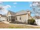 Rear exterior shows siding, grey roof, and a screened-in porch next to a concrete pad at 22 Hill Row Ln, Clayton, NC 27527